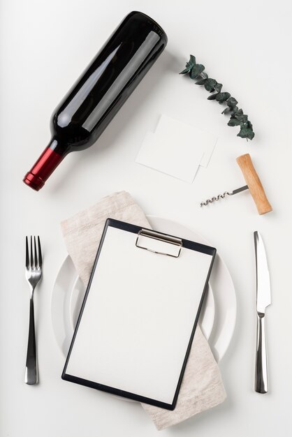 Top view of empty menu with wine and corkscrew