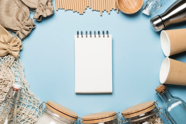 Free photo top view empty notepad with eco friendly objects