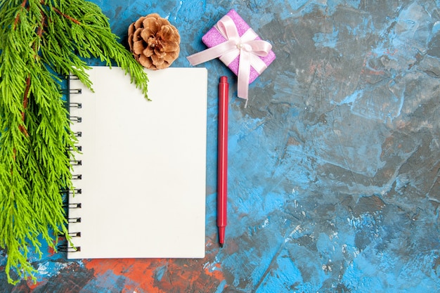 Top view empty open notebook with green branch