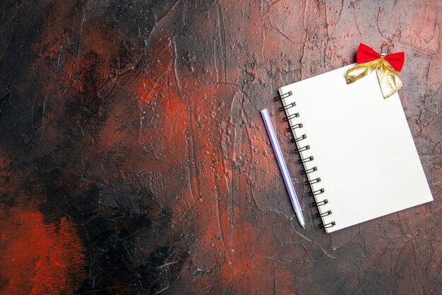 Top view empty open notepad with bow