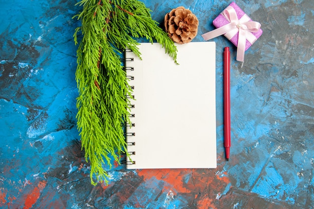 Top view empty open notepad with green branch