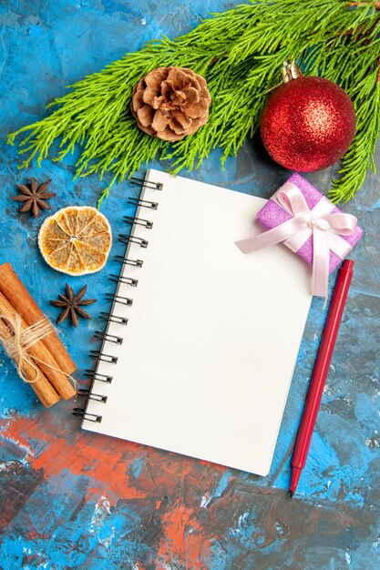 Top view empty open notepad with green branch