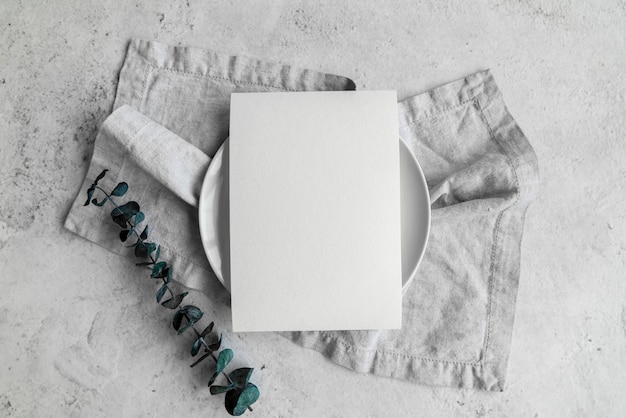 Top view of empty paper on plate with leaves