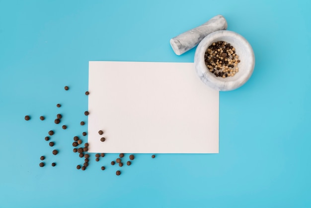 Free photo top view of empty paper with mortar and pestle