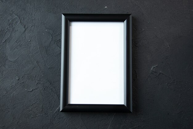 Top view of empty picture frame on a dark wall