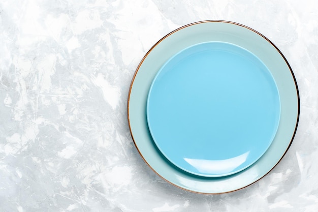 Бесплатное фото Вид сверху пустая круглая тарелка синего цвета на белом столе