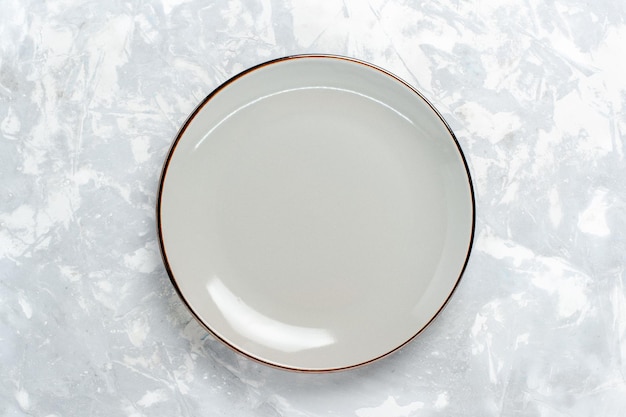 Top view empty round plate on white surface