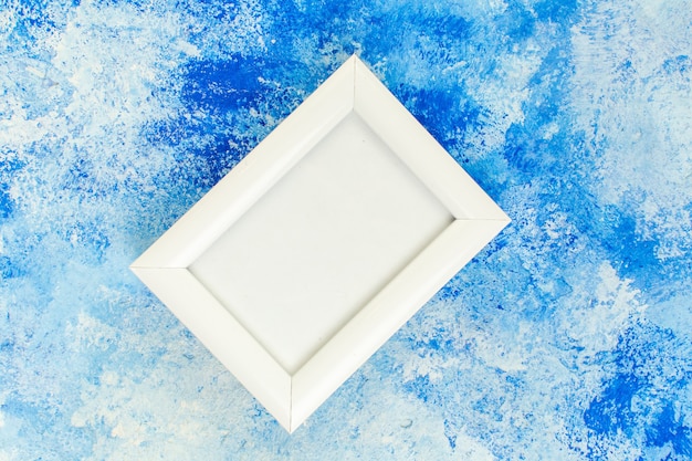 Free photo top view empty white frame on blue white grunge