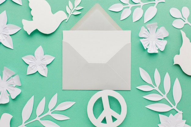 Top view of envelope with peace sign and paper dove