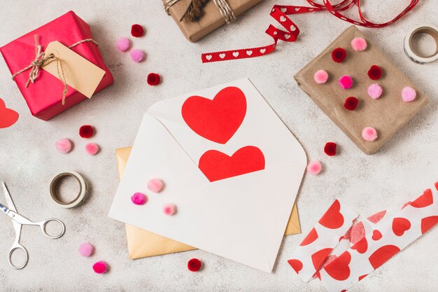 Top view of envelopes with hearts and gifts