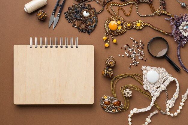 Top view of essentials for bead working with notebook