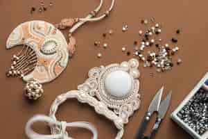 Free photo top view of essentials for bead working with scissors