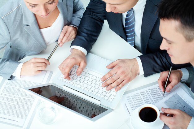 Top view of executives with laptop and cup of coffee