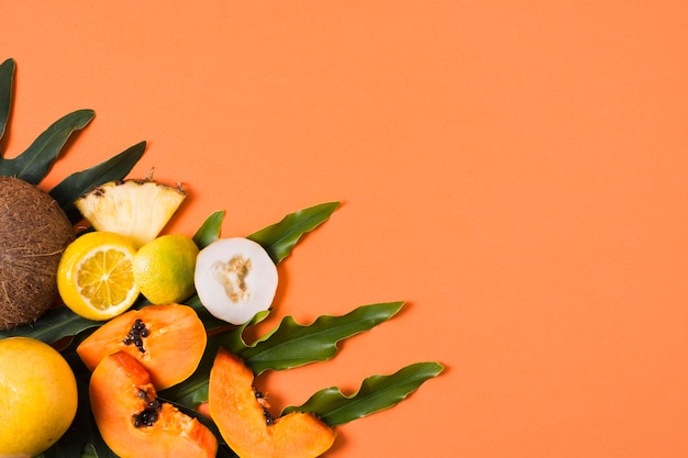 Free photo top view exotic fruits on the table with copy space