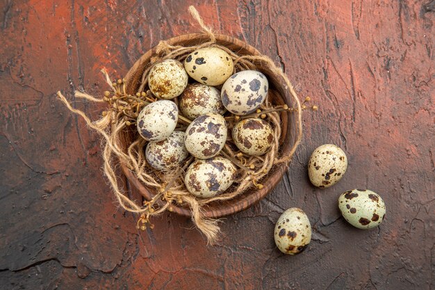 Top view of farm fresh eggs on a wooden pot inside and outside on a brown background