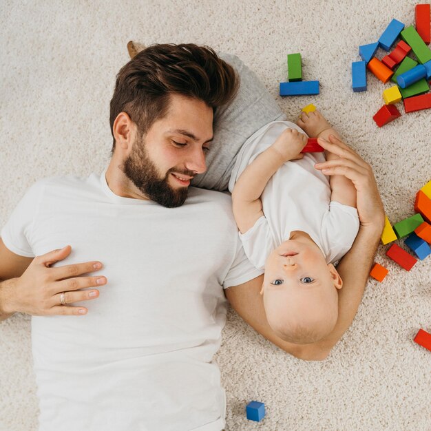 Top view of father and baby at home