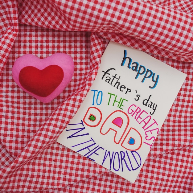 Top view of father's day greeting card on checkered canvas