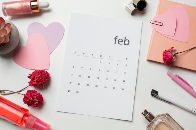 Top view february calendar and flowers