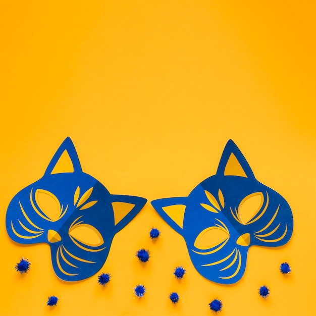 Top view of feline carnival masks with copy space