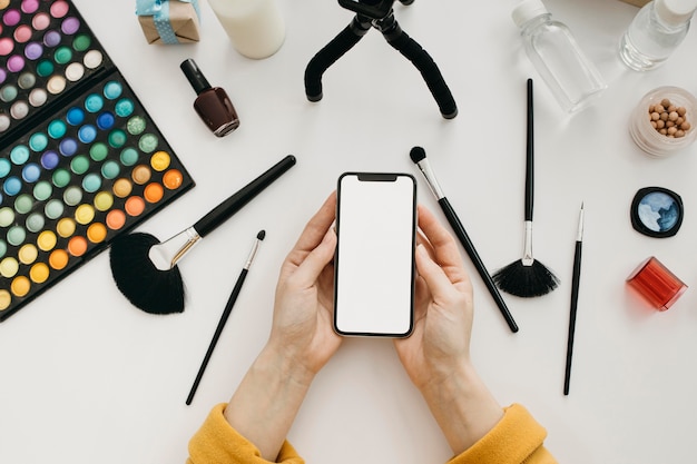 Top view of female blogger streaming online with smartphone