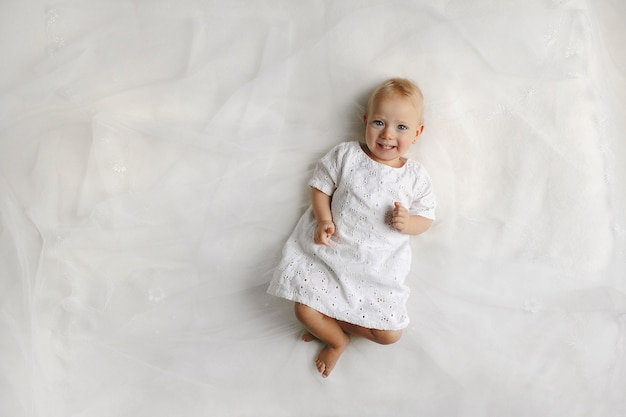 Top view on the female little baby lying on the bed