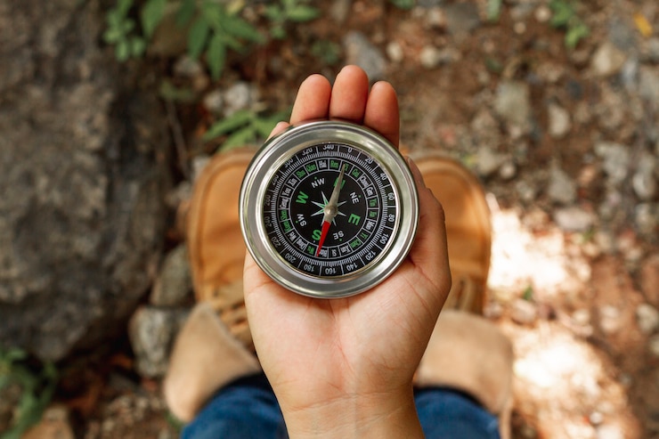 Free Photo top view female using compass for directions