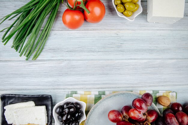 Top view of feta cheese with fresh sweet grapes pickled olives