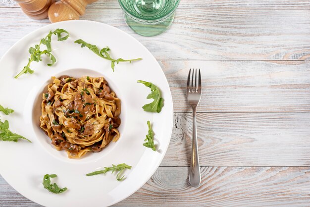 Top view of fettuccine pasta on wooden table
