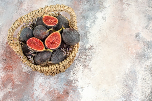 Top view fig basket cut figs on grey background