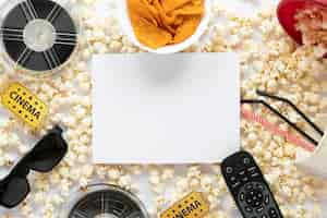 Free photo top view film elements composition on white background with white card