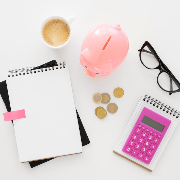 Top view financial elements assortment with empty notepad