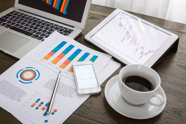 Top view of financial reports next to a cup of coffee