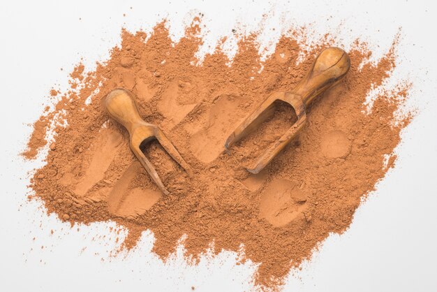 Top view of fine powder with wooden scoops