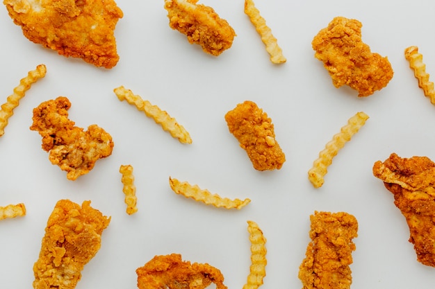 Top view of fish and chips scattered on surface