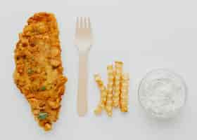 Free photo top view of fish and chips with sauce and fork