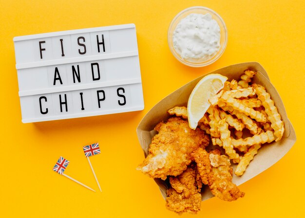 Top view of fish and chips with sauce and light box