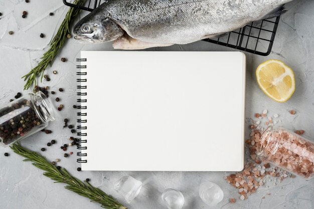 Top view fish and notebook arrangement