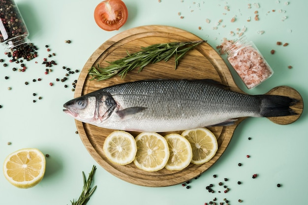 Top view fish with herbs and lemon