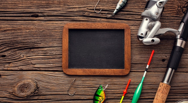 Top view of fishing essentials with blackboard and copy space