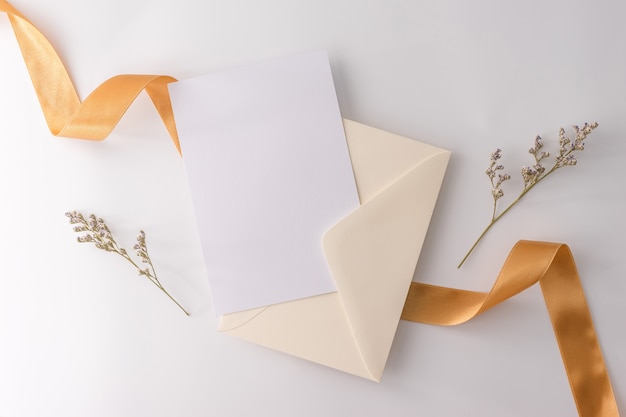 Top view, flat lay, wedding invitation card, envelopes, cards papers on white background.