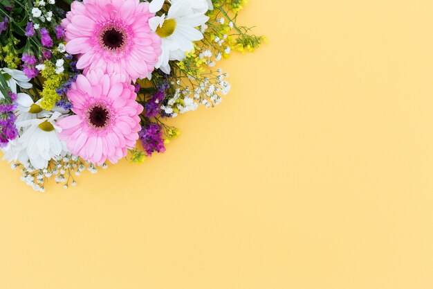 Top view floral frame with yellow background