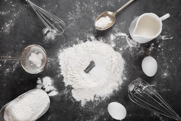 Top view flour with baking tools on the table