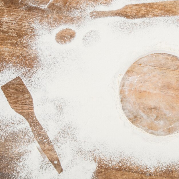 Top view of flour on wooden surface