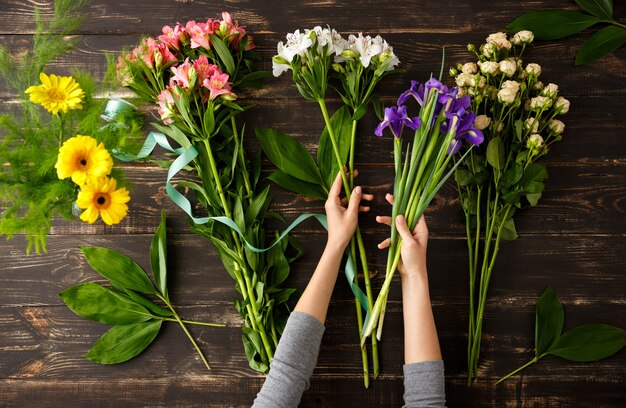 Top view of flowers, process of making bouquet