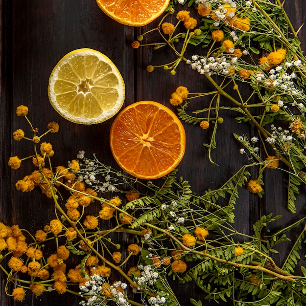 Top view of flowers with citrus fruits