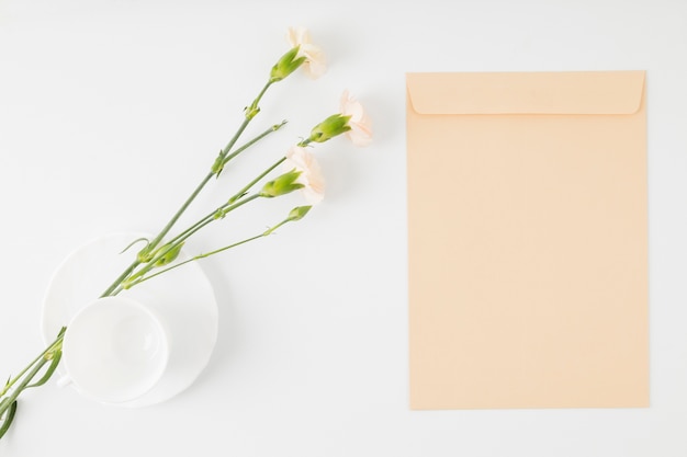 Top view flowers with envelope and cup