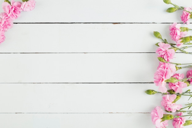 Top view flowers on wooden background with copy space