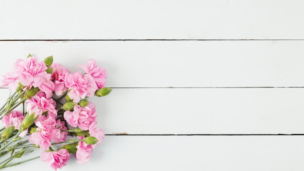 Top view flowers on wooden background with copy space