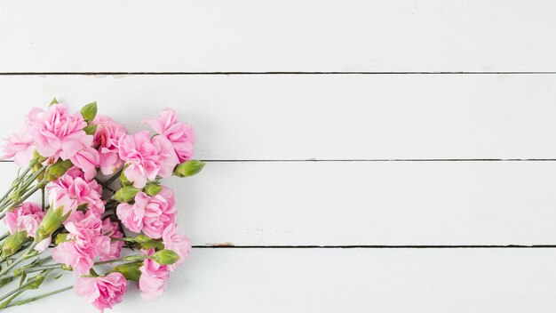 Top view flowers on wooden background with copy space