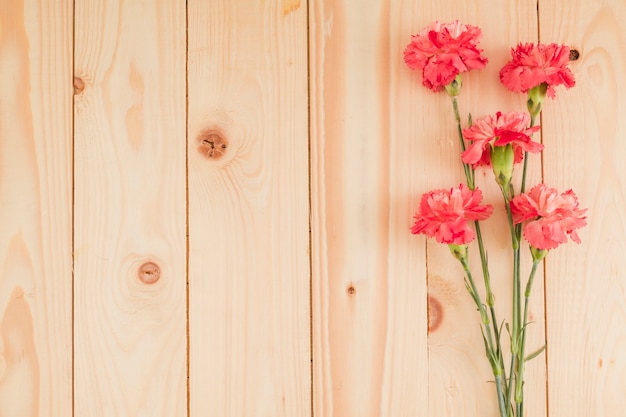 Top view flowers on wooden background with copy space